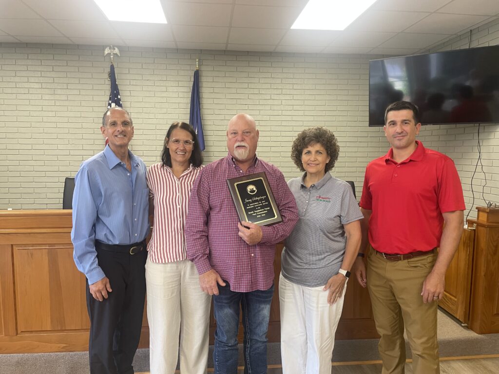 Former South Tangipahoa Parish Port Commission (STPPC) member Jimmy Schliegelmeyer, Jr. receives a plaque from the STPPC at its July 23, 2025 meeting, as a sign of appreciation for his 4-years (2020-24) of dedicated community service to the board that serves at the State of LA's legal authority for the Port Manchac inter-modal terminal.  (Pictured from Left to Right)  STPPC President Daryl Ferrara, STPPC Vice-President Tina Roper, former STPPC member Jimmy Schliegelmeyer, Jr., STPPC Secretary Rhonda Sheridan & STPPC Treasurer Timothy DePaula.